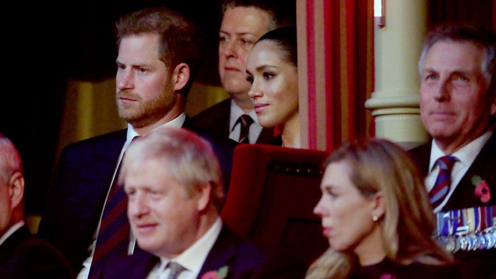 Prince Harry and Meghan sat in the Royal Box, behind the prime minister and his girlfriend Carrie Symonds (foreground)