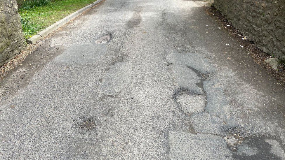 A road with several potholes