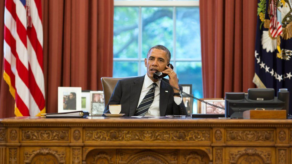 President Barack Obama talks with President Hassan Rouhani of Iran during a phone call in the Oval Office.