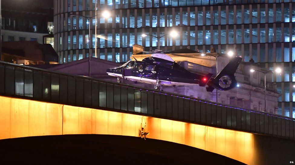 A helicopter lands on London Bridge.