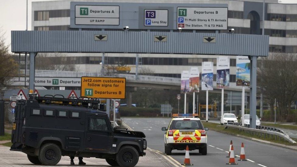 An armed police vehicle is seen at Manchester Airport in Manchester