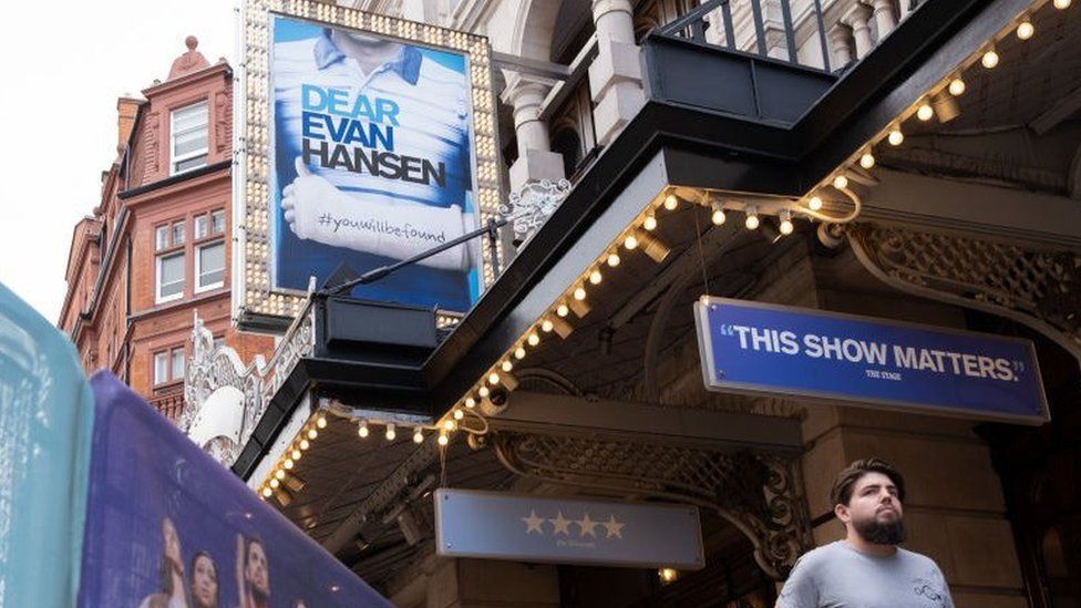 Adverts for Dear Evan Hansen outside the  Noel Coward Theatre on St. Martin's Lane in Theatreland, London.