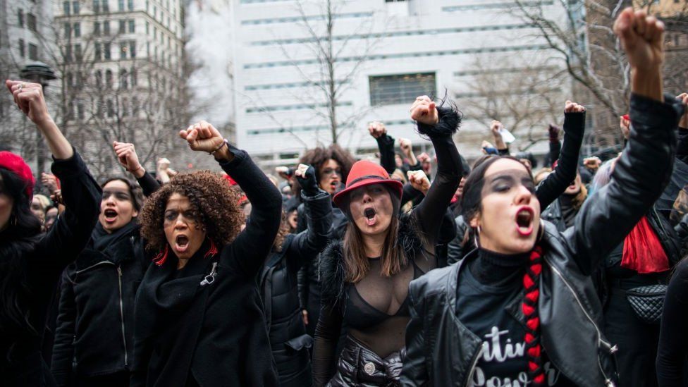 Women protesting with fists in the air in front of the court where Hollywood mogul Harvey Weinstein attends a pretrial session - 10 January 2020