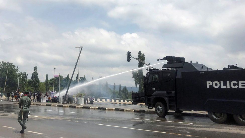Police use water cannons to disperse people protesting against alleged brutality by members of Nigeria"s Special Anti-Robbery Squad (SARS), in Abuja, Nigeria October 11, 2020.