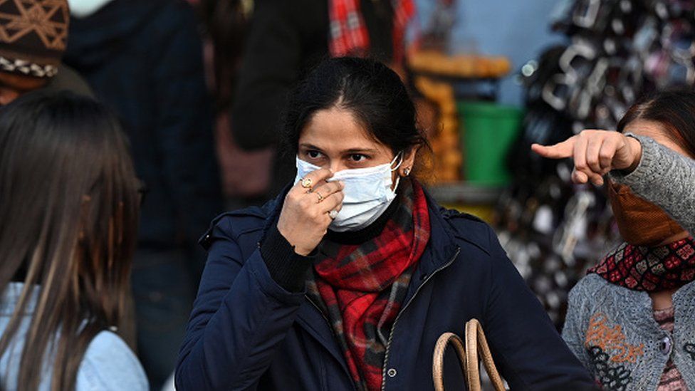 People wear masks as a precautionary measure from COVID at Sarojini Nagar Market in Delhi