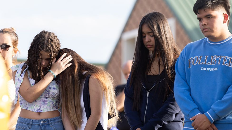 Students and community members pray at a memorial outside of Apalachee High School on September 5, 2024 in Winder, Georgia.