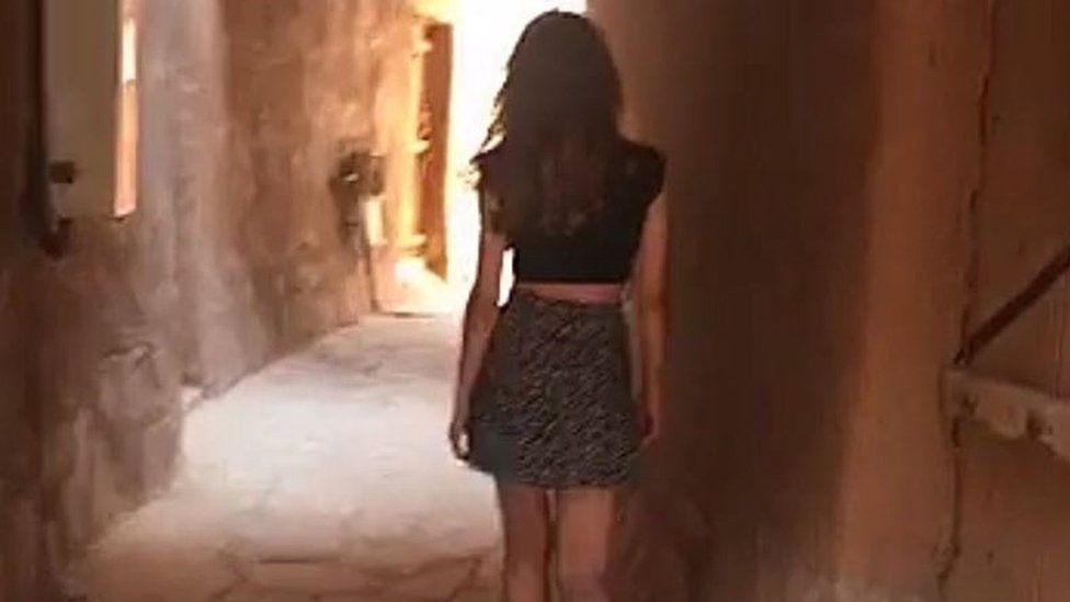 Screengrab from video posted by "Khulood" showing a woman walking through a historic village in Saudi Arabia