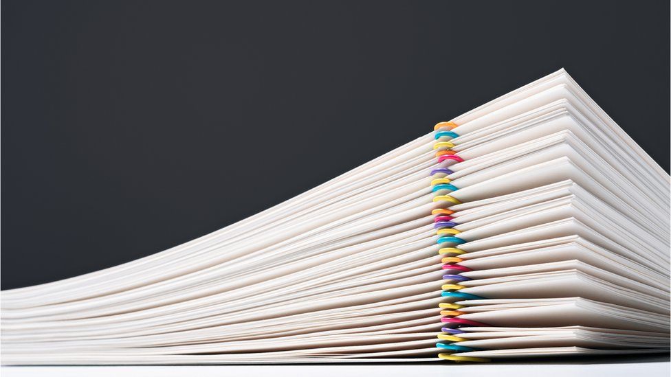 Stacked Paper Files With Colourful Paper Clips - stock photo