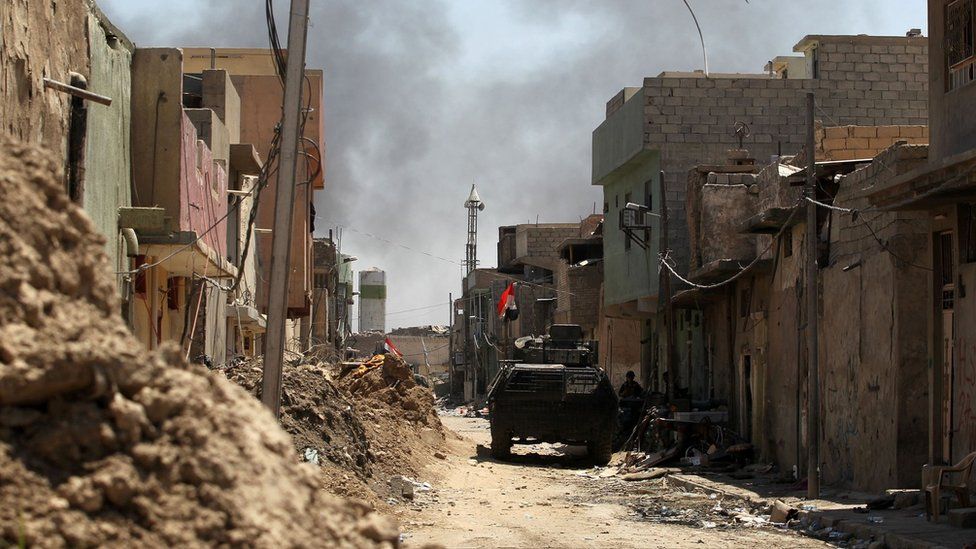 Smoke billows as Iraqi forces advance towards the Old City of Mosul on 19 June 2017