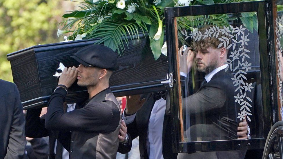 Max George (left) and Jay McGuiness of The Wanted (centre) carry the coffin at the funeral of their bandmate Tom Parker at St Francis of Assisi church in Queensway, Petts Wood