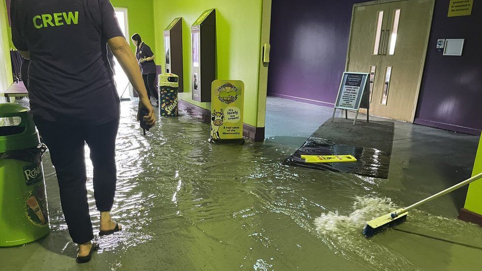 Staff clearing out floodwater inside The Milky Way Adventure Park in north Devon