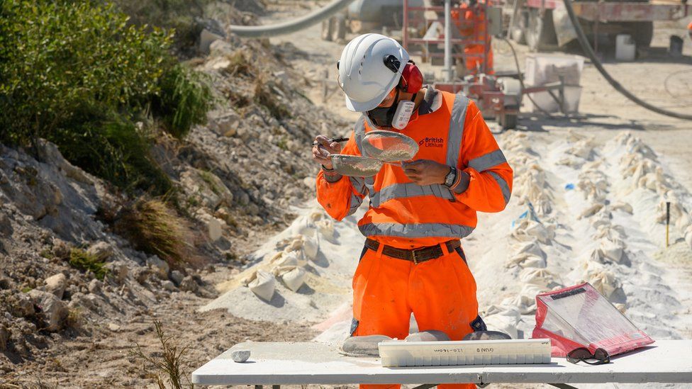 Man examining potential lithium on site