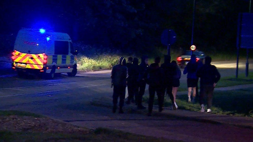 A handful of youths are dispersed from the scene by police