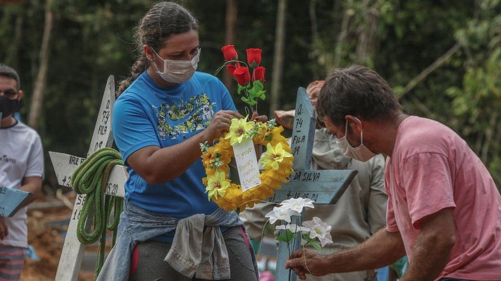 Mourners at a burial site in Manaus