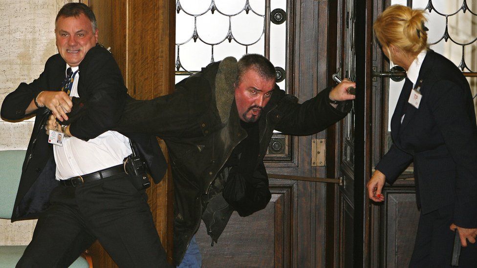 Michael Stone being restrained by security guards during his attack at Stormont in 2006