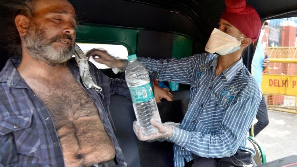 A Covid-19 patient waits for a bed outside Lok Nayak Jai Prakash (LNJP) hospital, on May 3, 2021 in New Delhi, India.