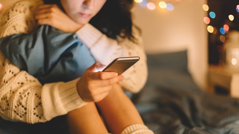 File photo: Girl texting on smartphone at home