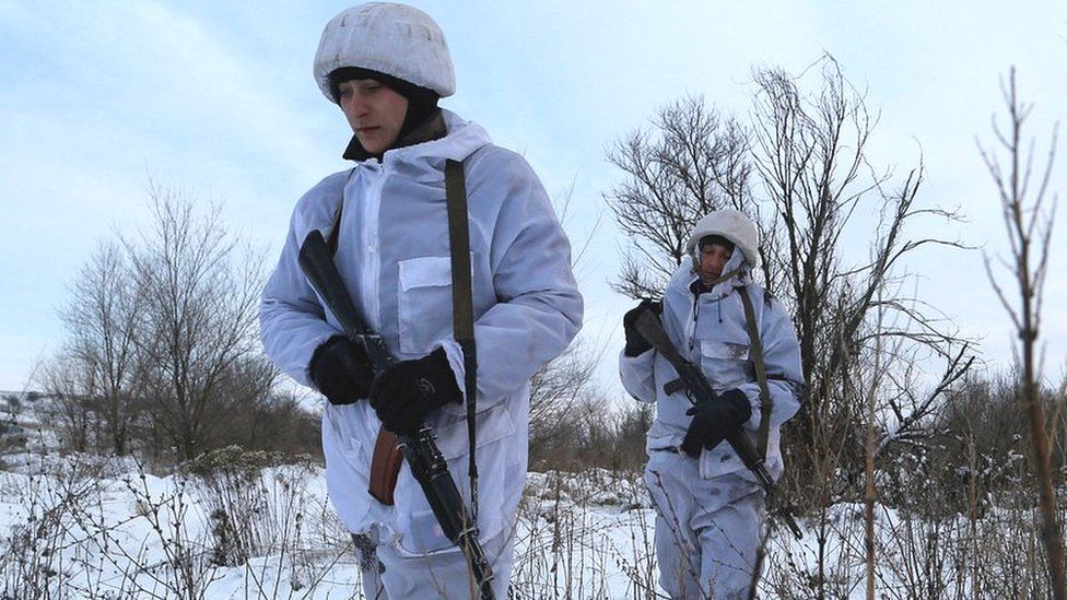 Militants of the self-proclaimed Luhansk People"s Republic walk at a fighting position on the line of separation from the Ukrainian armed forces near the settlement of Frunze in Luhansk Region on 24 Dec 2021