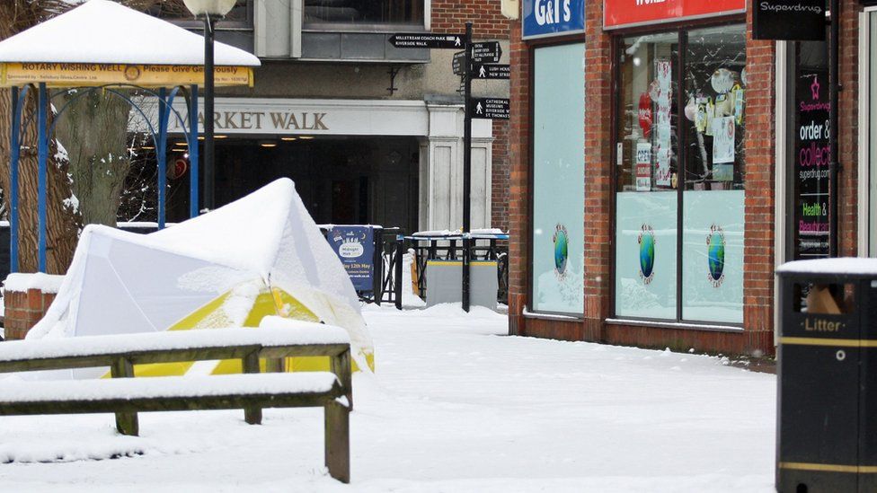 Snow-covered tent covering a bench at The Maltings shopping centre in Sailsbury