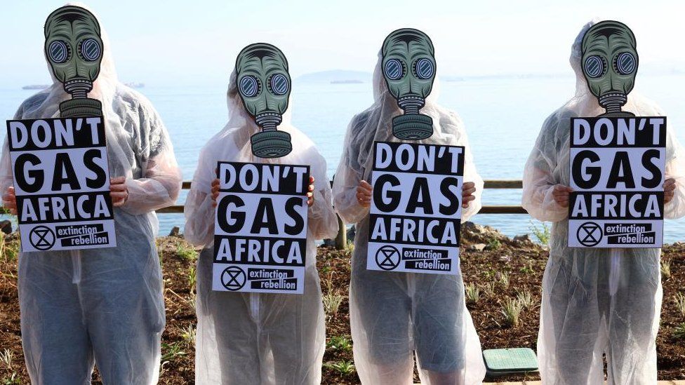 Climate activists from Extinction Rebellion hold placards outside the Africa Energy Week Conference as they staged a protest against the oil and gas industry, which they believe leads Africa down a path of environmental destruction, stranded assets, energy poverty and economic disaster, in Cape Town, South Africa October 18, 2022