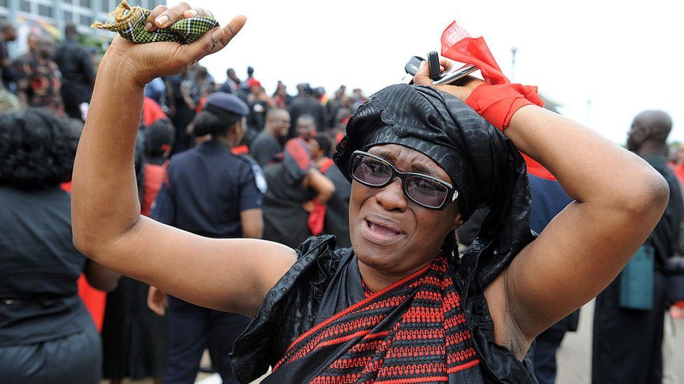 A woman mourns after viewing the body of late President John Atta Mills at the parliament in Accra on August 8, 2012