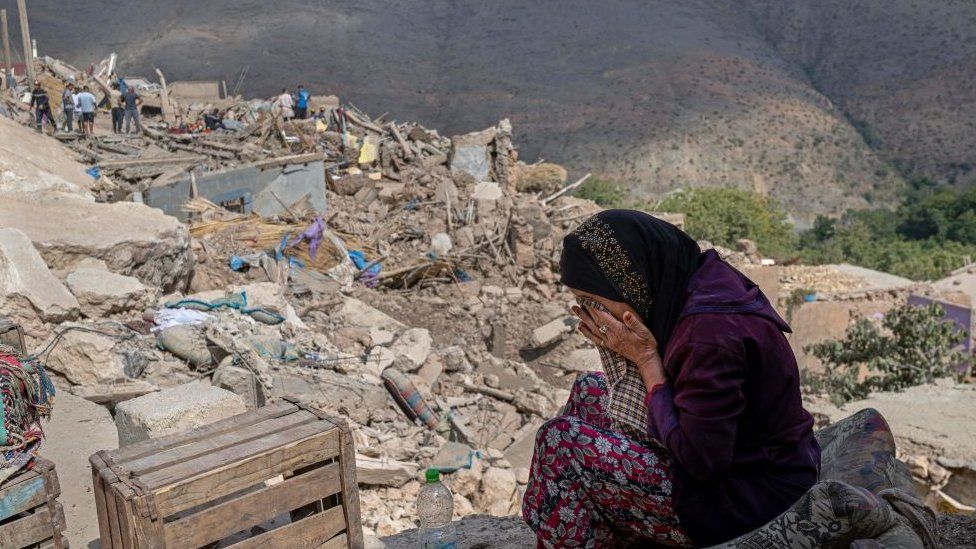 A woman cries by the rubble of destroyed houses amid ongoing rescue operations in the village of Imi N'Tala, near Amizmiz, on September 12, 2023 four days after the deadly 6.8-magnitude earthquake. Hopes dimmed in Morocco's search for survivors, four days after a powerful earthquake killed more than 2,900 people, most of them in remote villages of the High Atlas Mountains.