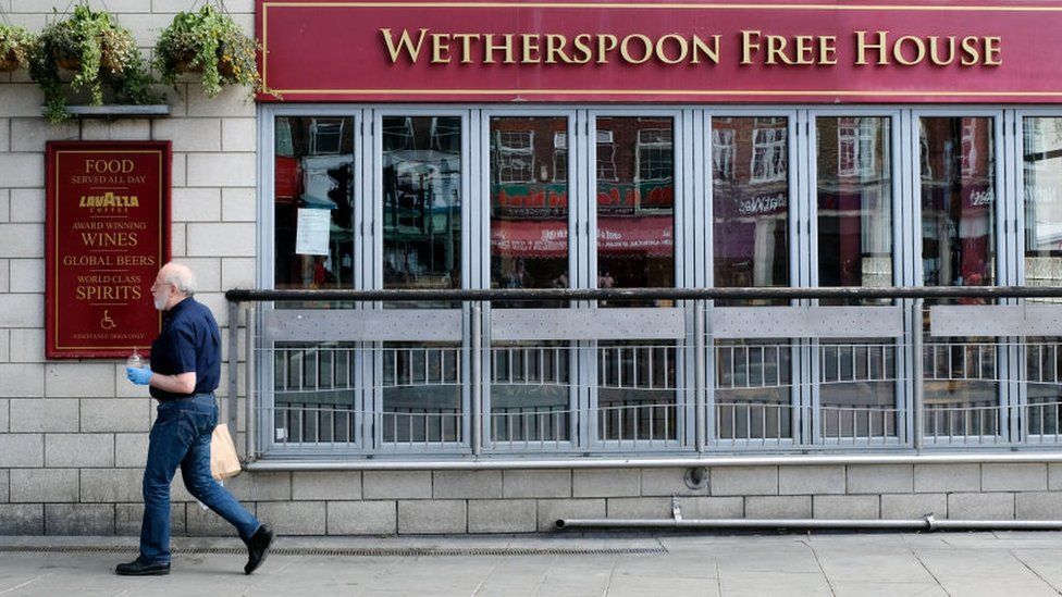 Man walks past Wetherspoons pub
