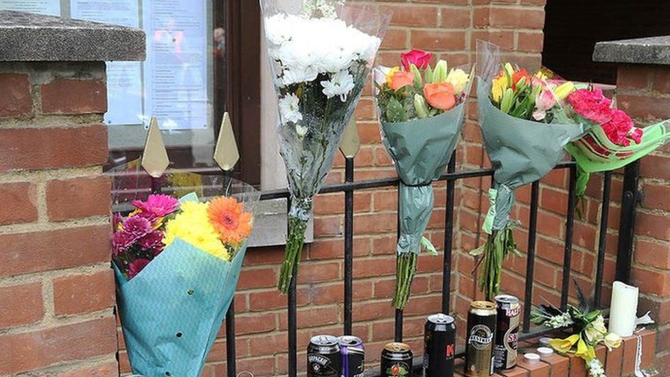 Flowers and drinks cans left outside Kempston Town Council building on Bedford Road, Kempston