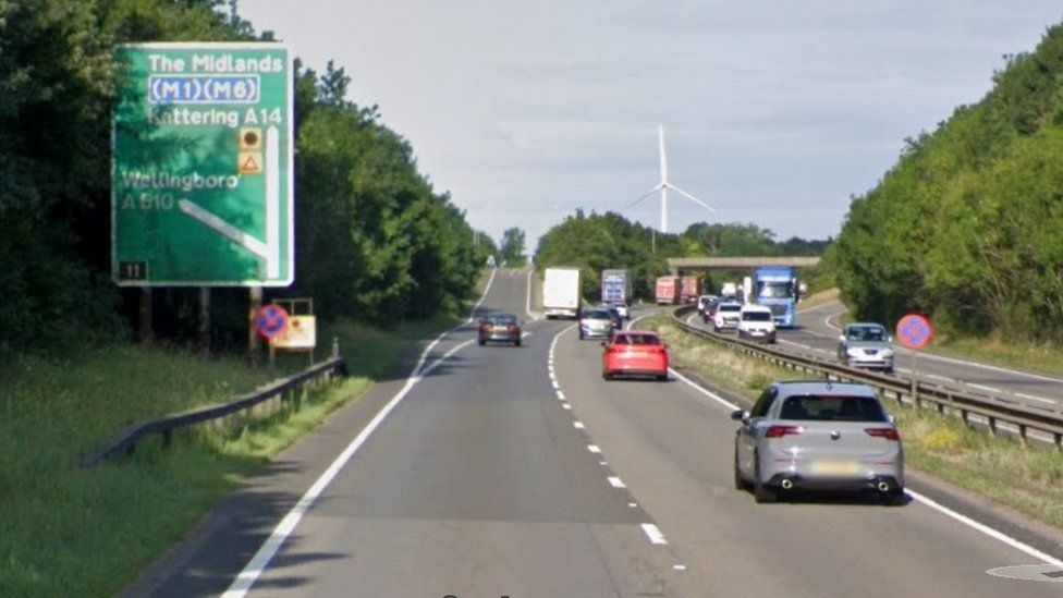 Dual carriageway with roadsign and junction beyond