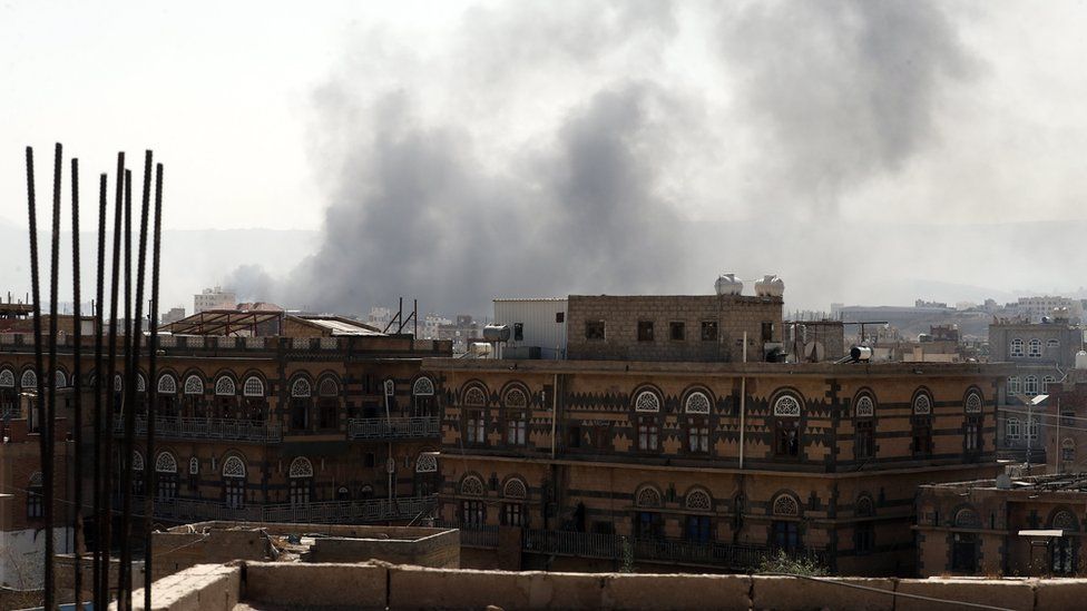 Smoke billows above a neighbourhood following Saudi-led airstrikes targeting positions in Sana"a, Yemen