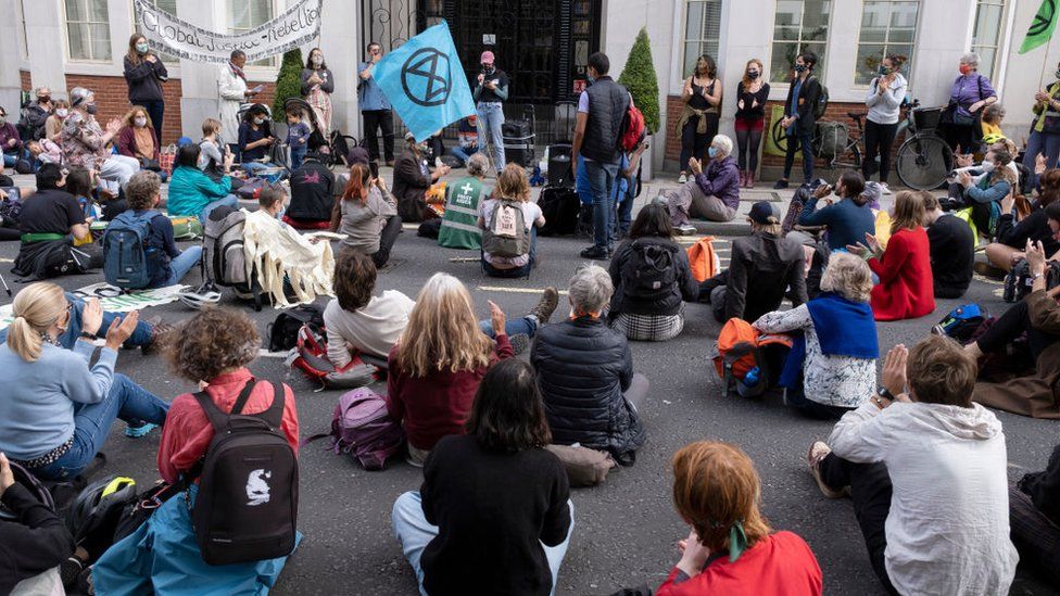 Extinction Rebellion protesters sitting on the road