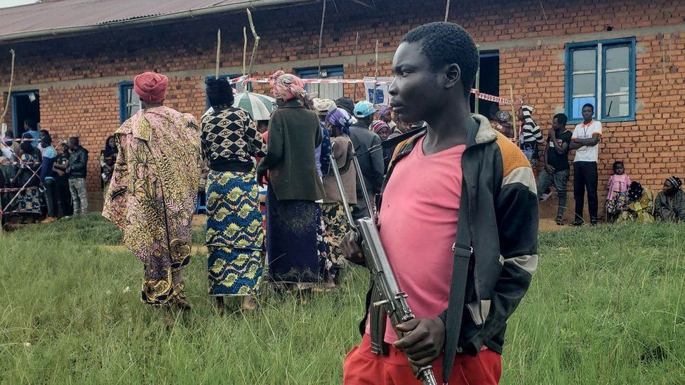 A Patriots Union for the Liberation of Congo (UPLC) militiaman stands guard at a polling station in Kalunguta, Beni Territory, North-Kivu Province, Eastern Democratic Republic of Congo, on December 20, 2023.