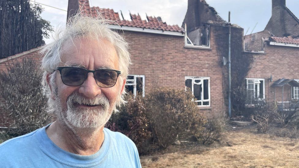 Keith Gant outside his burnt home in Ashmanhaugh, Norfolk