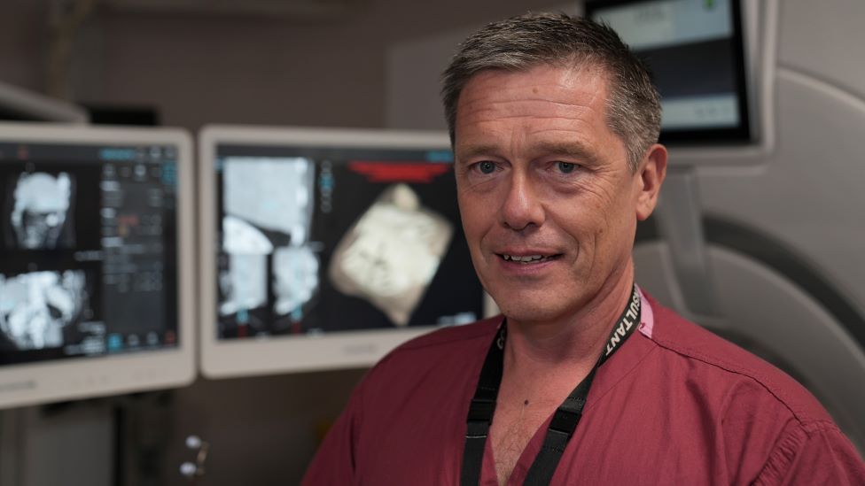 Dr Simon Smith in front of radiology computers.