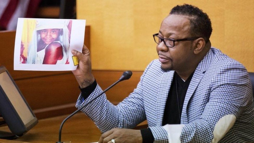 Bobby Brown holds up a picture of his daughter, Bobbi Kristina Brown, during a wrongful death case against her partner, Nick Gordon, in Atlanta (17 November 2016)