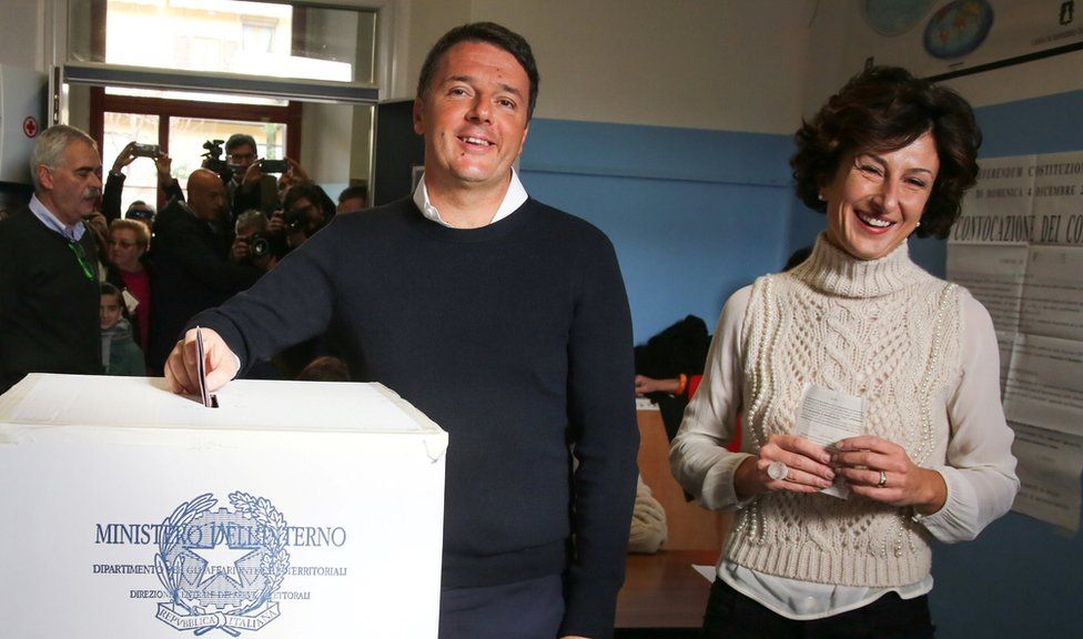 Italian Prime Minister Matteo Renzi casts his vote for the referendum on constitutional reform as he is flanked by his wife Agnese, in Pontassieve, near Florence, northern Italy December 4, 2016