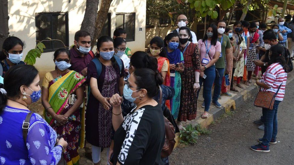 Health workers queue to receive a dose of a Covid-19 coronavirus vaccine at the Cooper hospital in Mumbai on January 16, 2021.