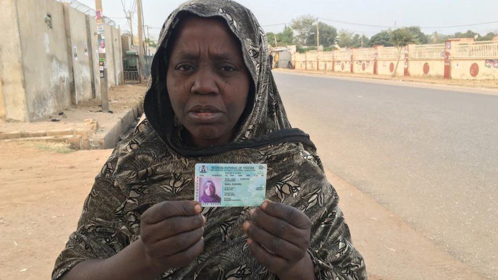 Woman holding a voter's card