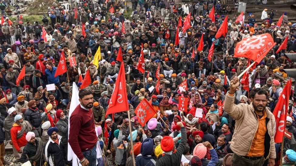 Activists of Communist Party of India Marxist (CPIM), along with members of different workers unions, shout slogans as they block train tracks during a nationwide general strike called by trade unions aligned with opposition parties to protest against the Indian government's economic policies, near the railway station in Amritsar on January 8, 2020.