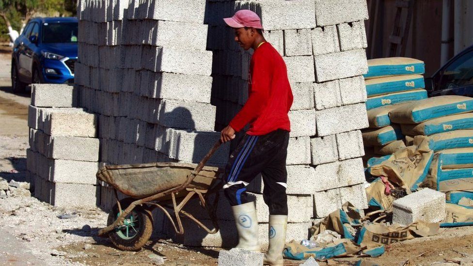 A young Egyptian man working at a building site in Libya