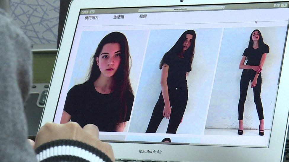 The photo shows a laptop screen with three images of the model, in a black top and trousers in various poses