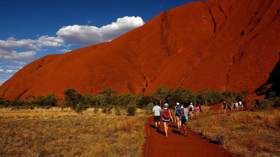 Tourist visiting Uluru in 2013