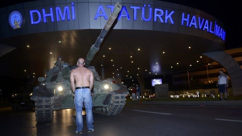 A man stands in front of a Turkish army tank at Istanbul's Ataturk airport. Photo: 16 July 2016