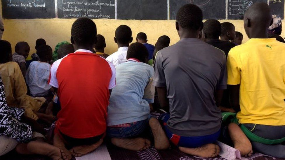 Pupils write their lesson as they listen their teacher during class at a pilot school of the Global Partnership for Education, in Tivaouane, near Dakar, on January 31, 2018.