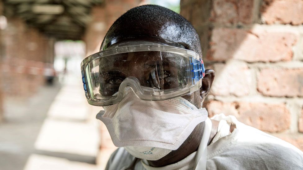 A health worker wears protective equipment as he looks on at Bikoro Hospital on 13 May