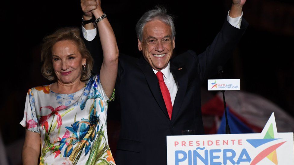 Sebastian Pinera next to his wife celebrating his victory on-stage