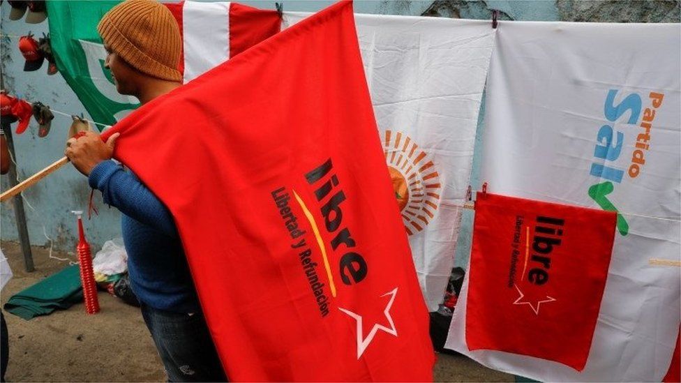 A street vendor sells political parties flags ahead of the November 28 general election, in Tegucigalpa, Honduras November 26, 2021