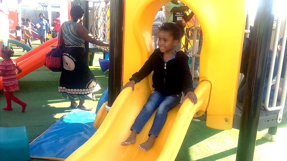 Robert Ntitima's daughter Sally Mika plays on a slide at an adventure playground in Lusaka, Zambia