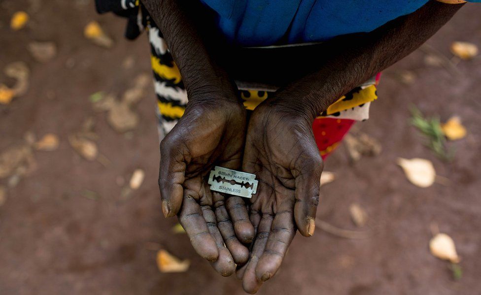 An FGM "cutter" in Kenya shows the razorblade she uses to cut girls' genitals