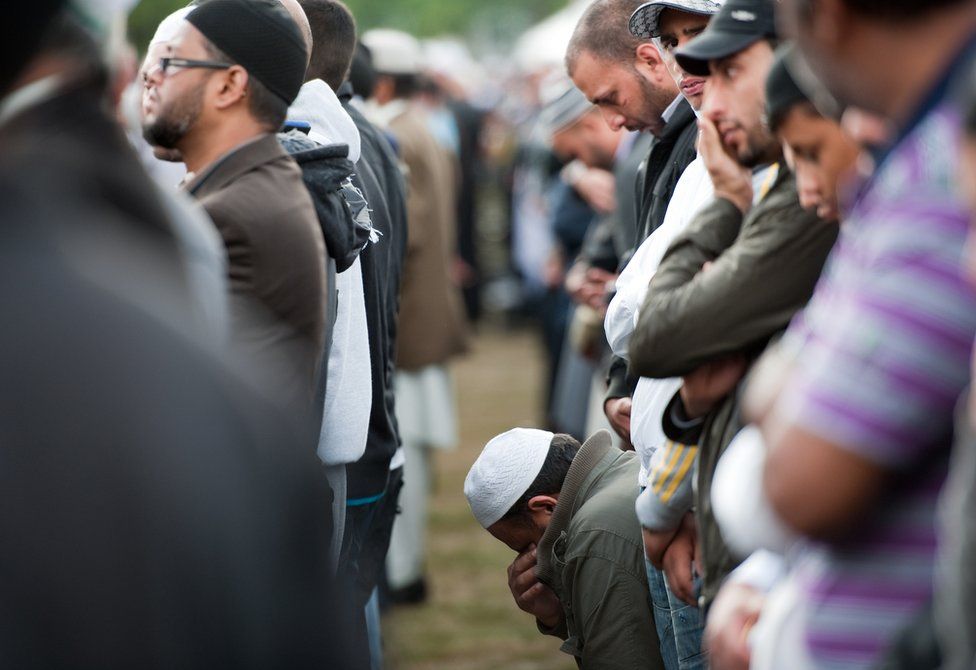 Muslim men shed tears at a funeral prayer